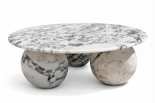 Marble coffee table with spherical bases on a white background