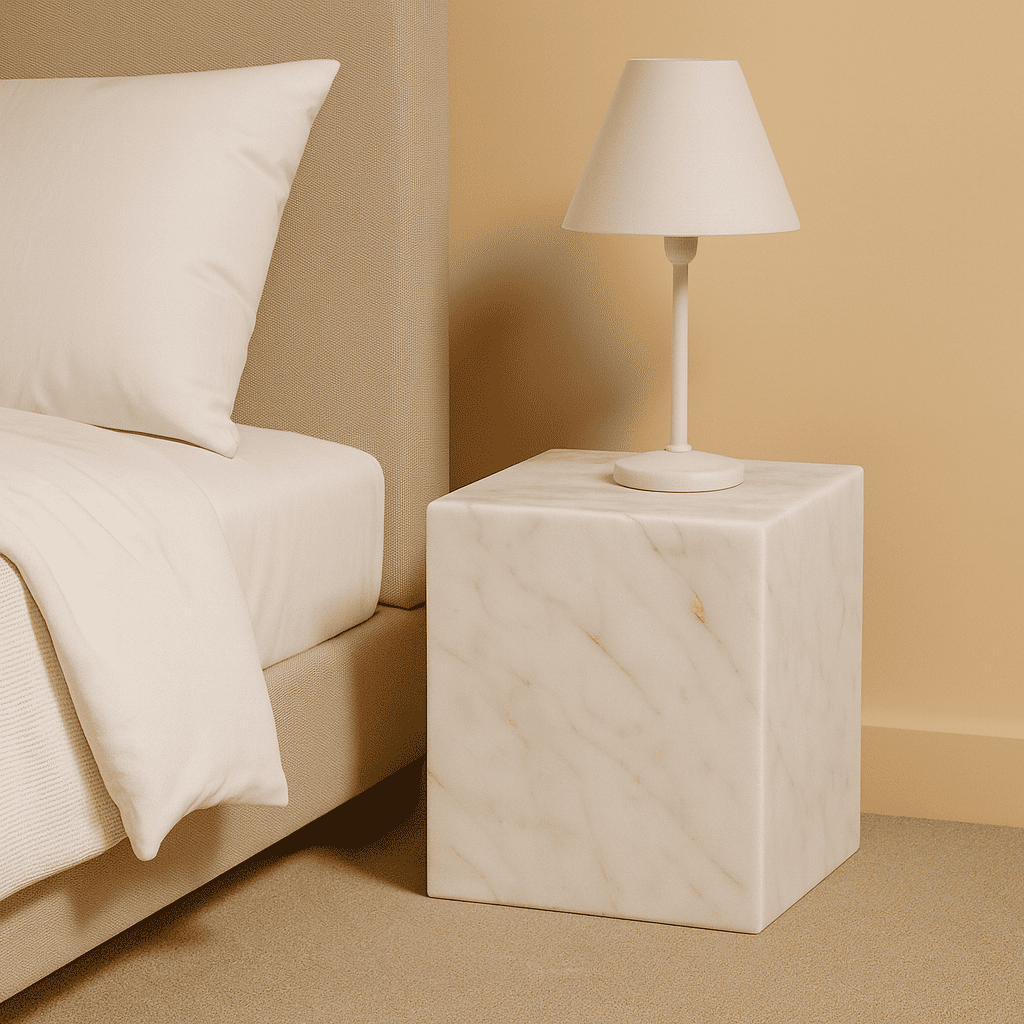 Marble nightstand with lamp next to a bed in a bedroom setting