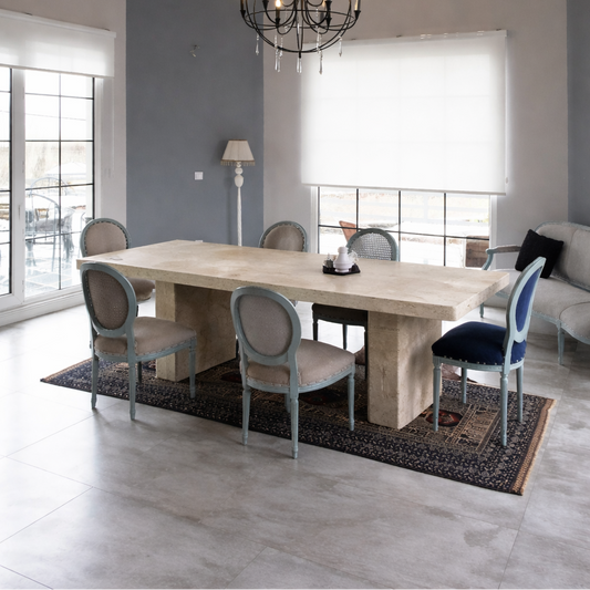 Modern dining room with a chandelier, table, and chairs. table is made of marble by aurora marble Sweden