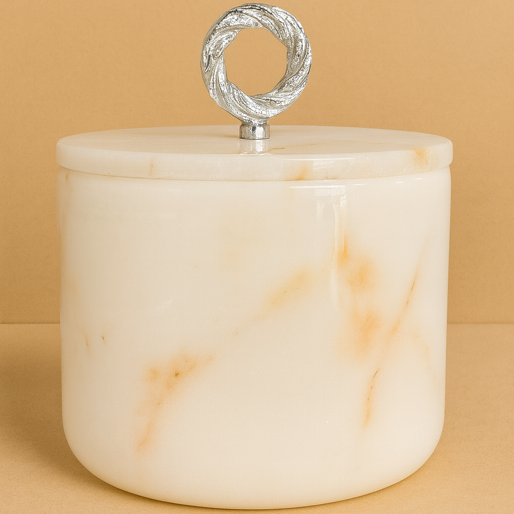 White marble jar with a silver lid on a beige background