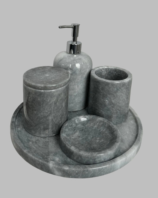 Sustainable 5-piece gray marble bathroom set with gold or silver pump. Includes dispenser, dish, tumblers, and tray. Handcrafted by Aurora Marble artisans.