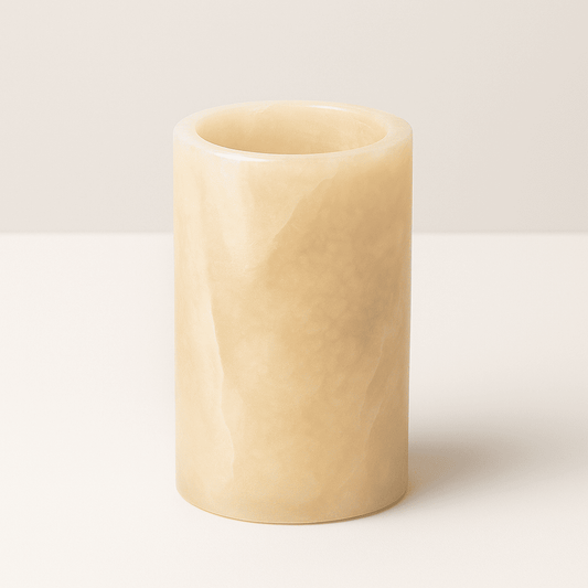Beige cylindrical marble vase on a white background