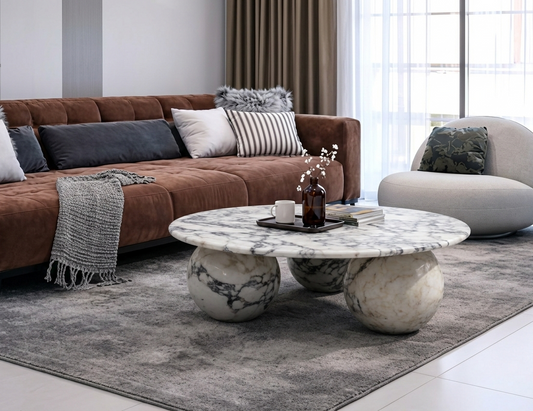 Modern living room with a brown sofa, marble coffee table, and decorative items.