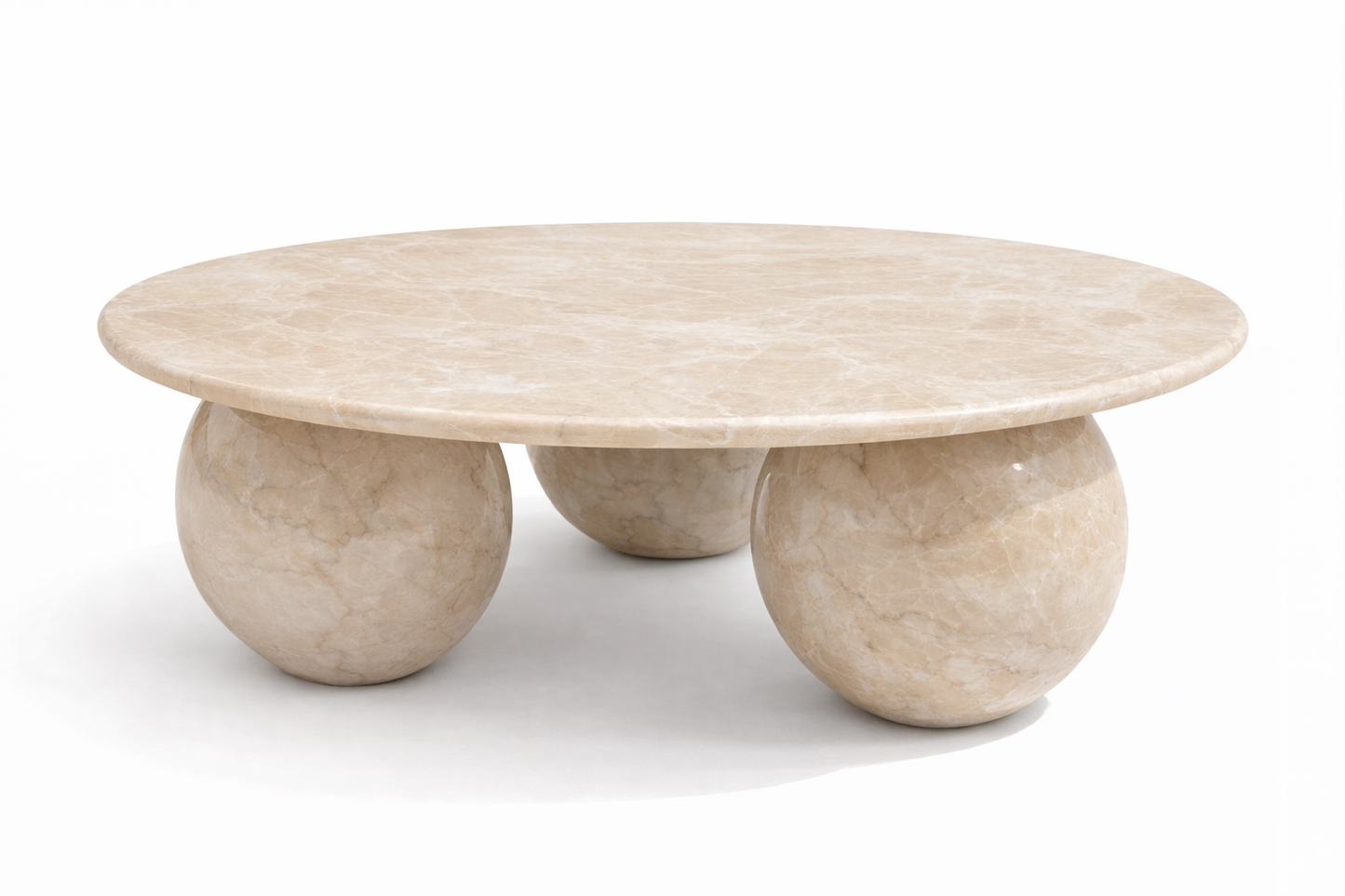 Beige marble coffee table with spherical bases on a white background