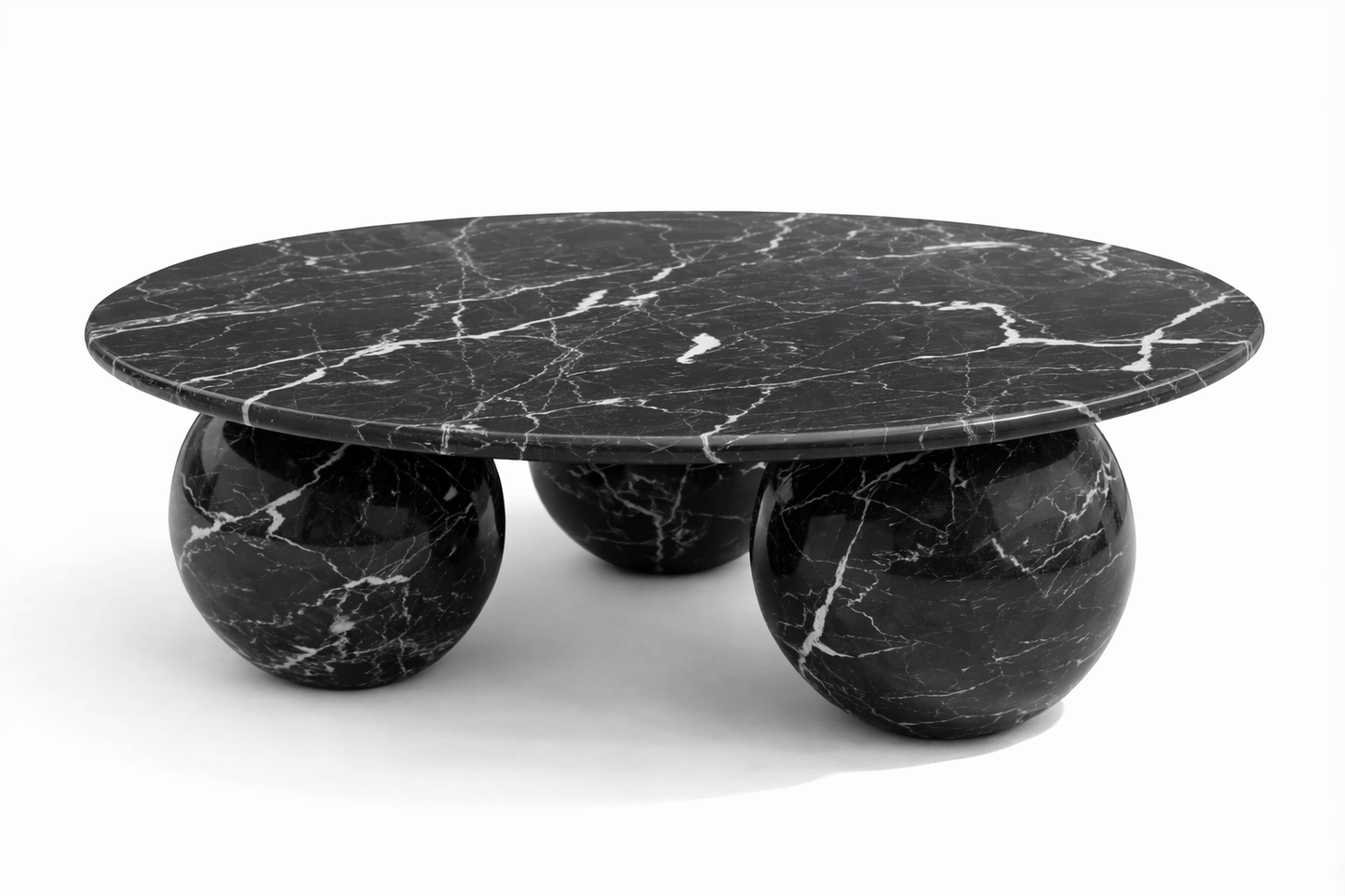 Black marble coffee table with spherical bases on a white background nero marquina black marble table
