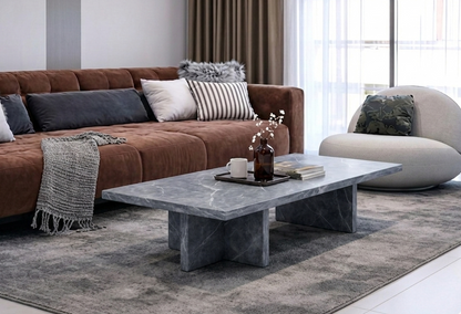 Modern living room with a brown sectional sofa, gray coffee table, and decorative pillows.