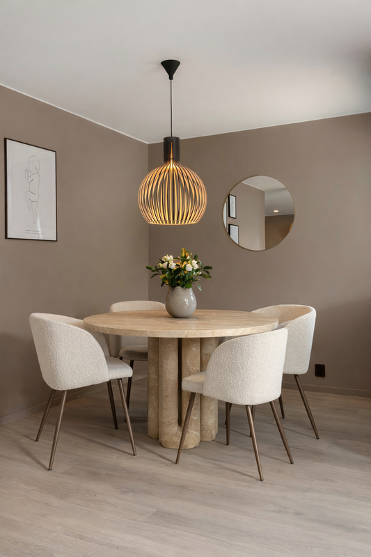Dining room with a travertine table and chairs, pendant light, and wall mirror.