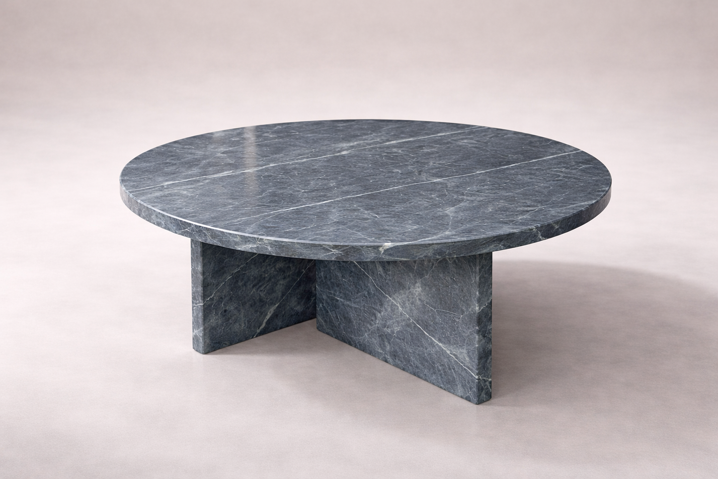 Round marble table with a gray veined pattern on a white background