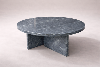 Round marble table with a gray veined pattern on a white background