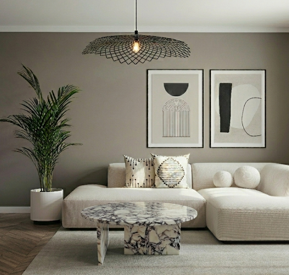 Modern living room with a beige sectional sofa, marble coffee table, and abstract art on the wall.