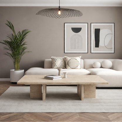 Modern living room with a beige sofa, beige marble coffee table, and abstract art on the wall.
