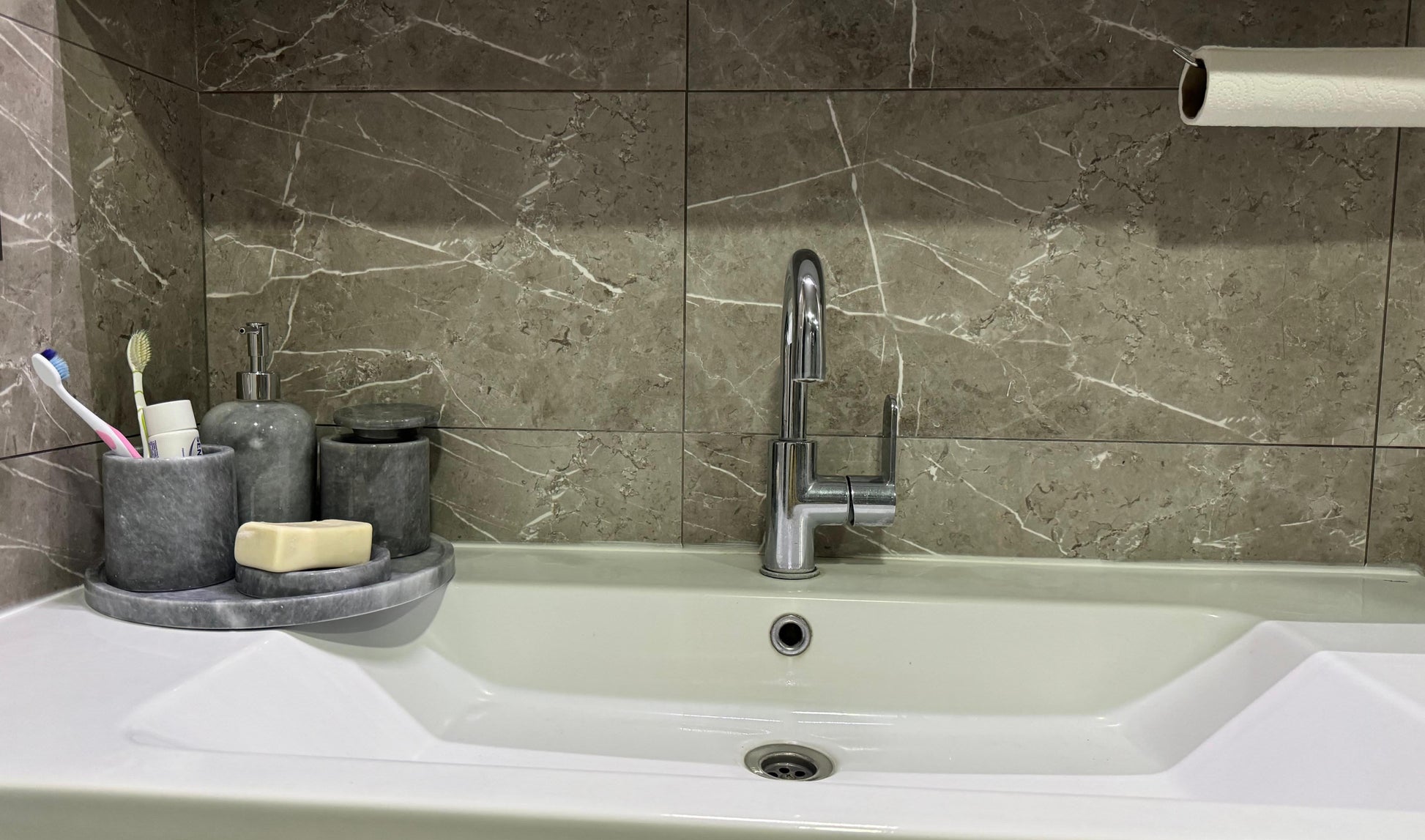 Sustainable 5-piece gray marble bathroom set with gold or silver pump. Includes dispenser, dish, tumblers, and tray. Handcrafted by Aurora Marble artisans.