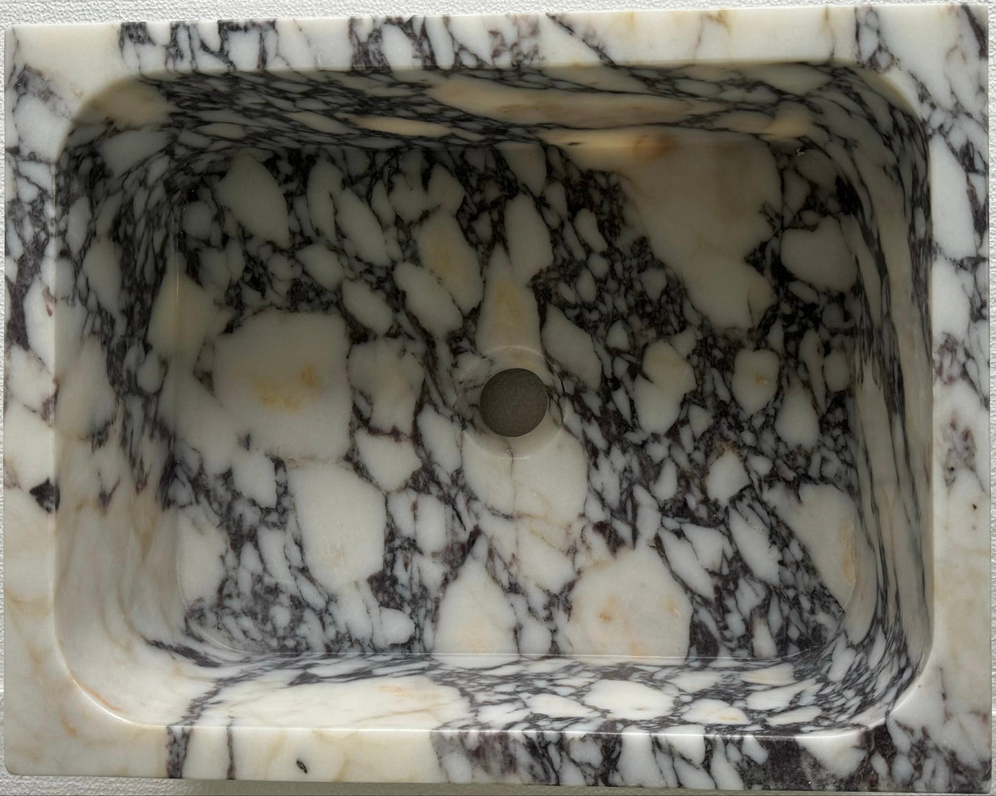 Luxury Calacatta Viola marble sink by Aurora Marble, featuring bold burgundy veining and minimalist sculptural design, handcrafted for high-end bathroom interiors.