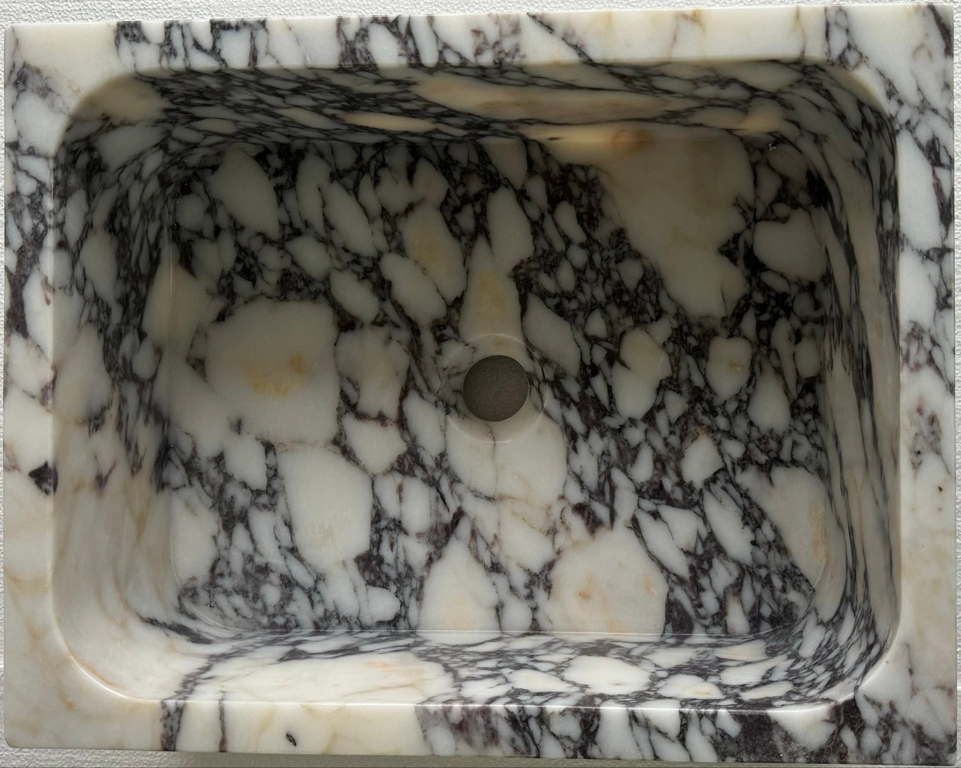 Luxury Calacatta Viola marble sink by Aurora Marble, featuring bold burgundy veining and minimalist sculptural design, handcrafted for high-end bathroom interiors.