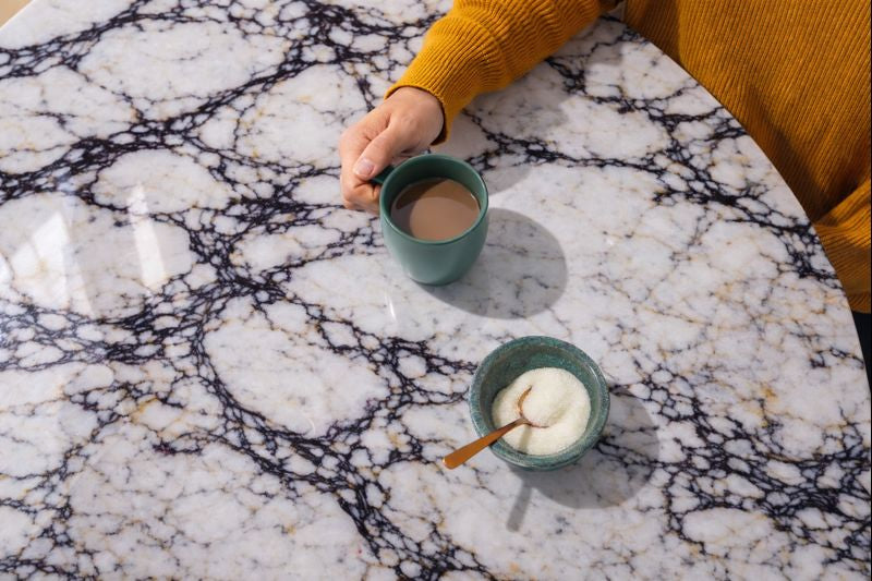 round dining table in calacatta viola marble close up view