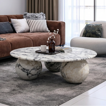 Modern living room with a brown sofa, sphere legged marble coffee table