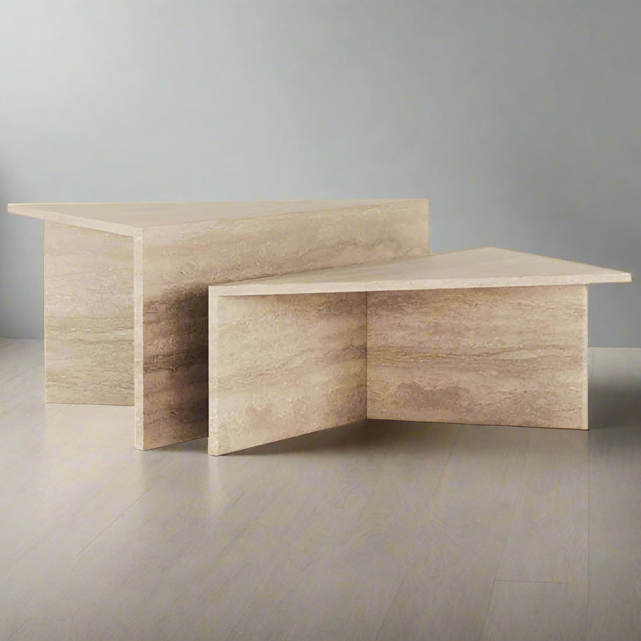 Two triangular Travertine coffee tables with geometric design, one larger than the other, placed on a grey surface.
